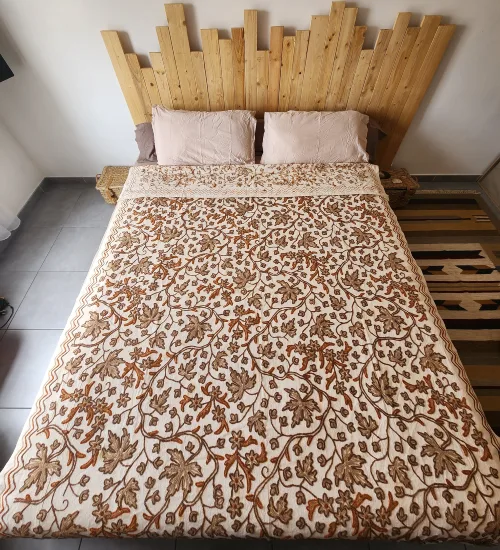 Wool Cotton Floral Embroidery Bedspread: Natural softness & discreet elegance presented on a bed