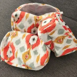 Various sizes of RANI handmade toiletry bags in quilted cotton with colorful abstract motif.