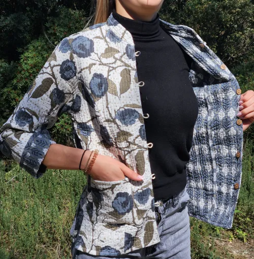 Woman wearing Indian khanta Anaya jacket open, revealing blue-printed interior.